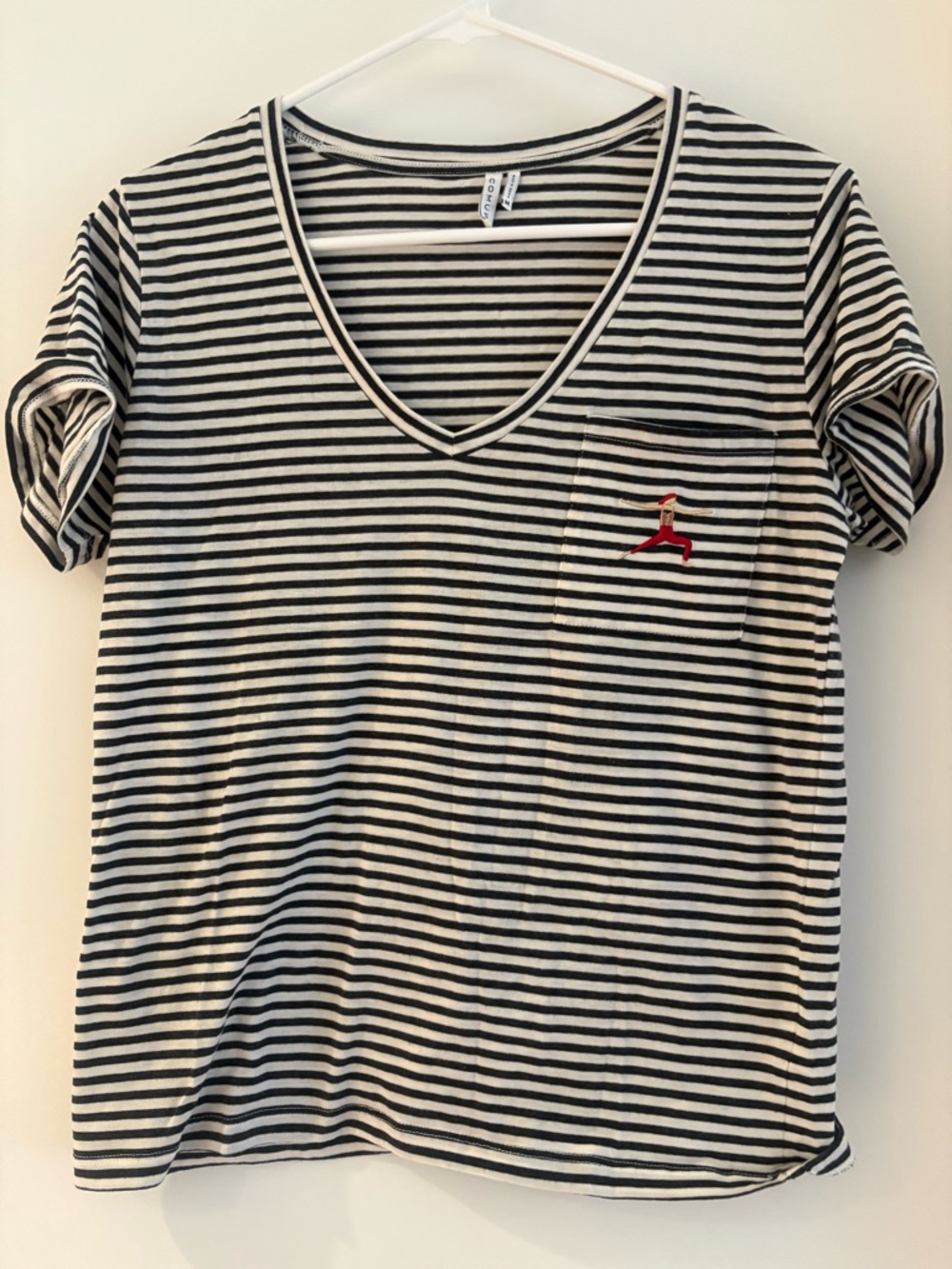 Women's Black & White Striped V-Neck Pocket Tee with Red Accented Yoga Pose